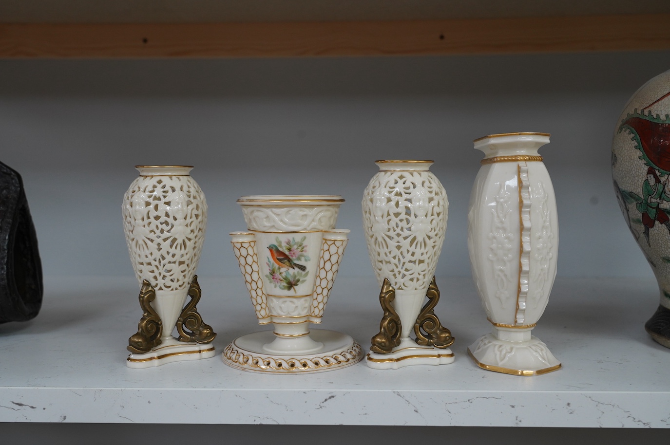 A pair of Royal Worcester or Grainger and Co. pierced urns and two other Worcester vases, tallest 16cm. Condition - good, some wear